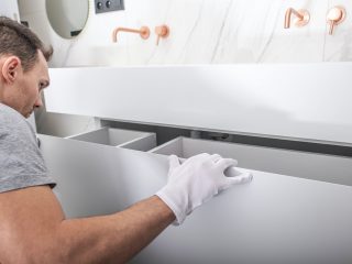 Modern Bathroom Cabinets Installation by Caucasian Worker